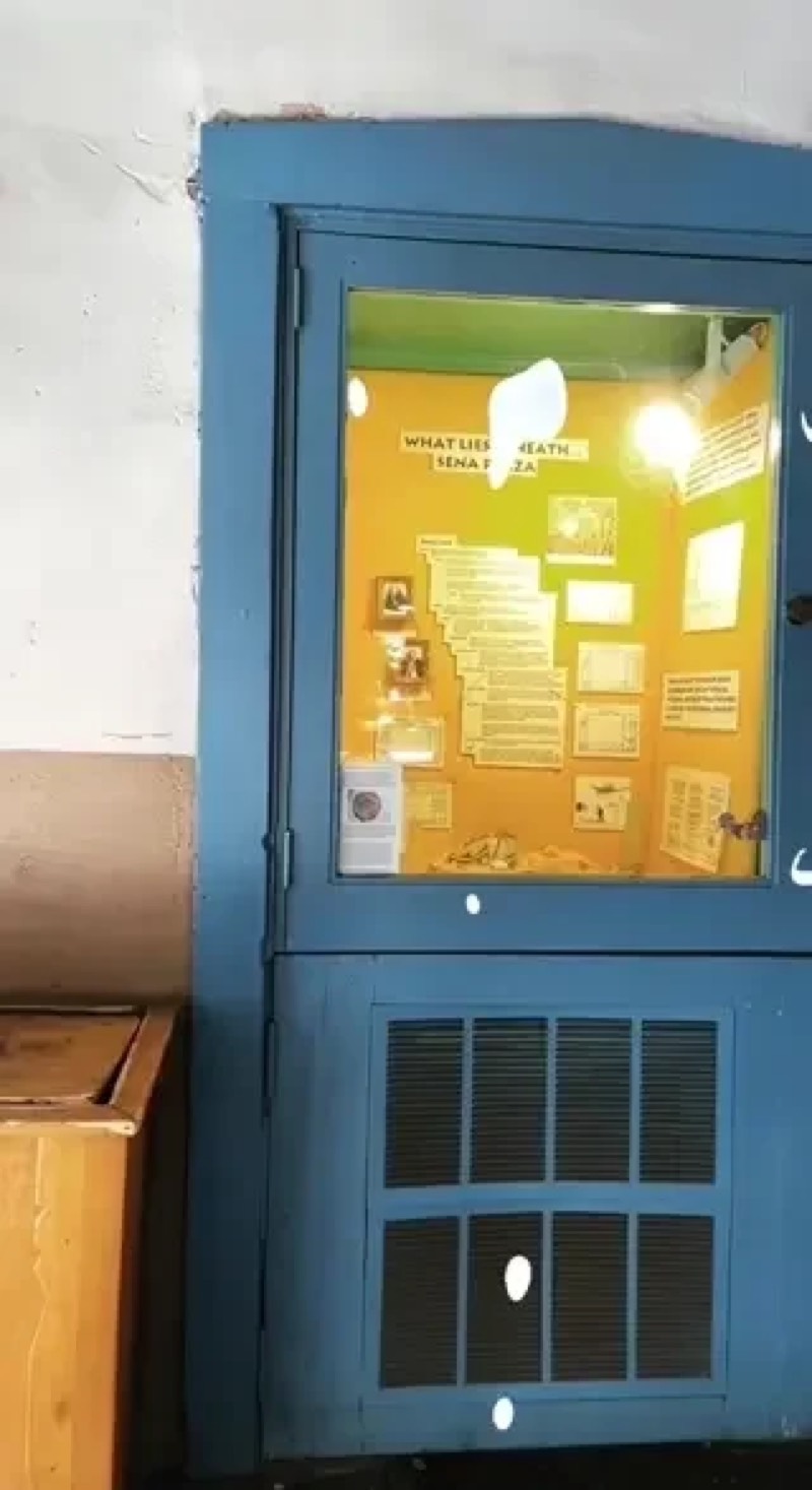 A blue wall cabinet with an AR display lit inside