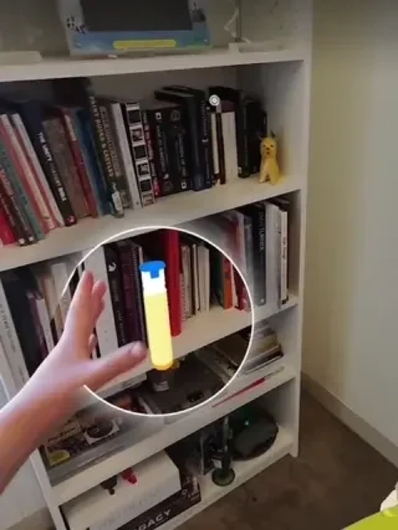 EpiPen guidance in the Spectacles view next to a bookshelf