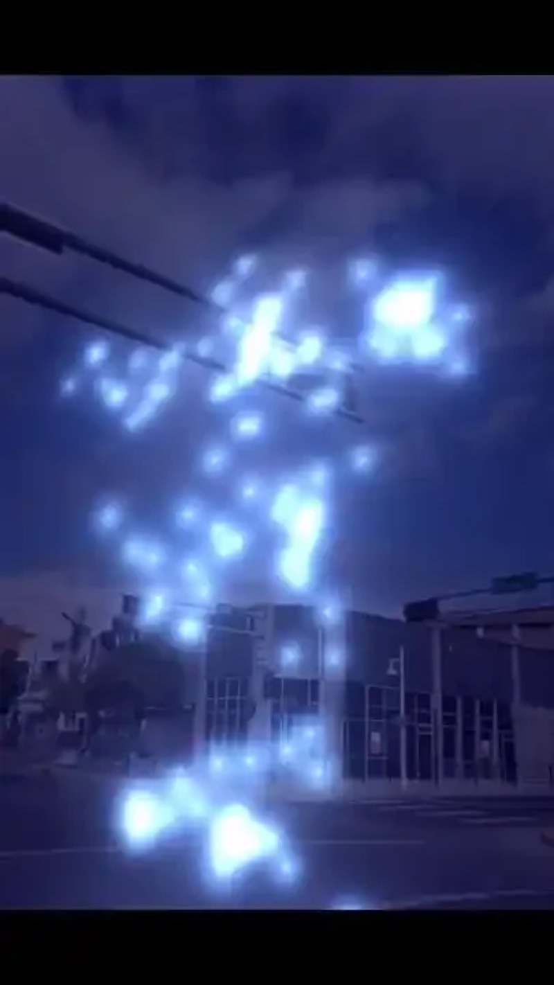 A glowing particle AR artwork on a phone
